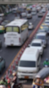 Bokeh view of road traffic near Central World shopping mall, Bangkok, Thailand. Blurred background vertical footage.