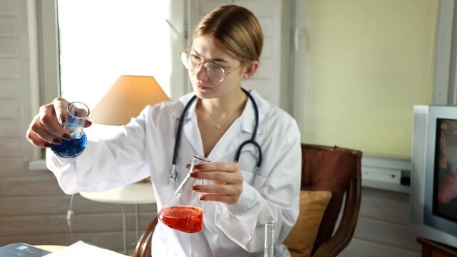 Female physician examines medicine ampoule and syringe with focused attention during careful clinical dosage preparation, checking sterile healthcare tools and liquid medicine indoors in sunlit room