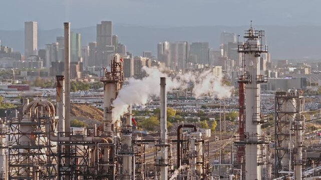 Refinery industrial close up with city skyline sunset drone video Denver, Colorado 4K