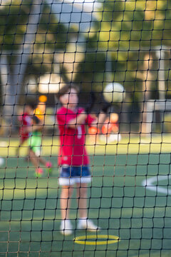 abstracted view of goalie net and goalie in late afternoon light