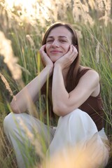 Beautiful woman resting in meadow on sunny day