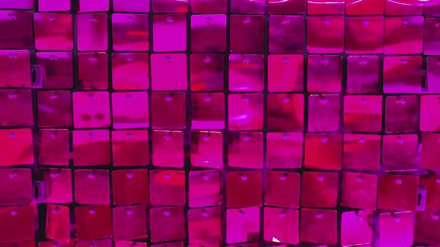 Static camera video showing a repeating pattern of red plastic blocks moving in the wind, creating rhythmic motion across the geometric surface