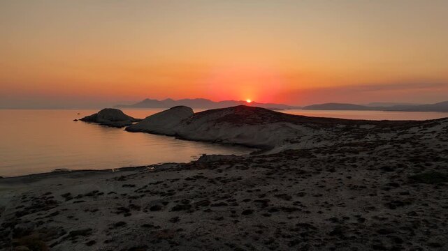 Sunrise over the Aegean sea of Greece surrounded Mandrakia beach in Milos island. 