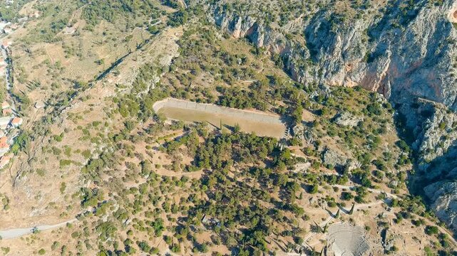 Delphi, Greece. Delphi Antique Stadium. Ruins of the ancient city of Delphi. Sunny weather in the morning, Summer. Drone footage
