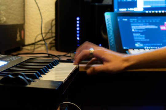 Hands of a person working with a synthesizer