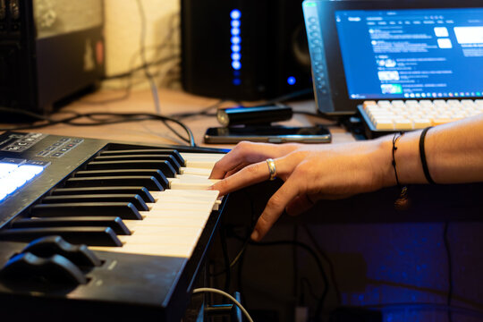 Hands of a person working with a synthesizer