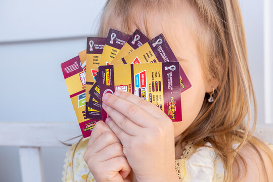 Young enthusiast Child holding Collecting football trading cards with logo on table, close up hands playing, sorting trading card game, Battle with friends, childhood Fan Culture, hobby collection