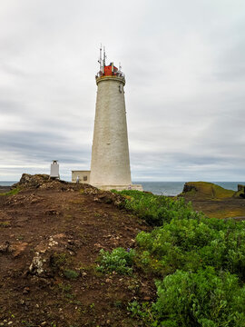 Reykjanesviti or Reykjanes Lighthouse, tall white building with red top. Stands on the coast of the Atlantic Ocean. Wild Icelandic landscape, next to Gunnuhver volcano. Reykjanes Peninsula, Iceland.