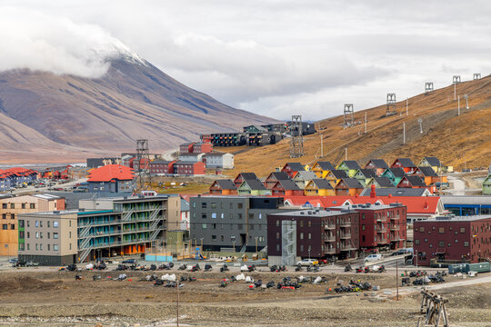 Summer cityscape of Longyearbyen with colorful houses, modern apartment buildings and barren Arctic mountain slopes under low clouds, Longyearbyen, Spitsbergen, Svalbard, Norway