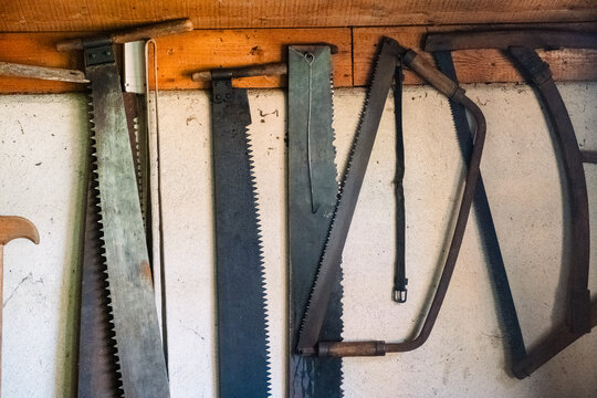 Old wooden saws hanging on a wall