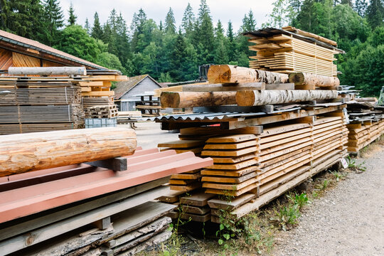 Wooden boards and logs stacked in a lumber yard