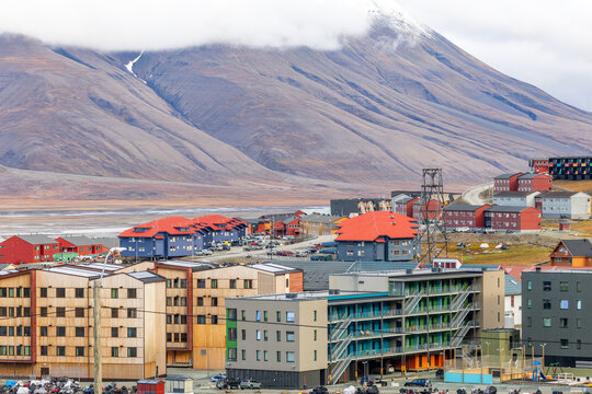 Modern residential buildings and colorful urban district with dramatic Arctic mountains in Longyearbyen, Svalbard, Norway