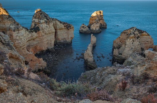 Golden hour view of limestone cliffs and sea arches at Ponta da Piedade in Lagos, Portugal