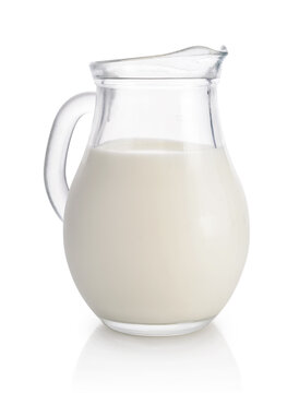 Milk in a glass pitcher isolated on a white