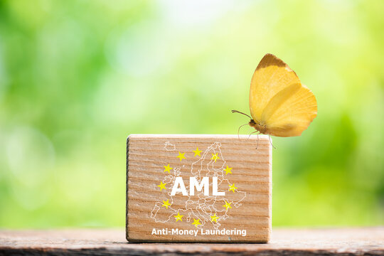 AML text on wood and icons on money background.