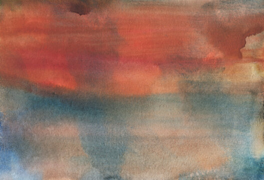 Watercolor background with hand painted faded colors in a blend of orange and blue tones on textured paper