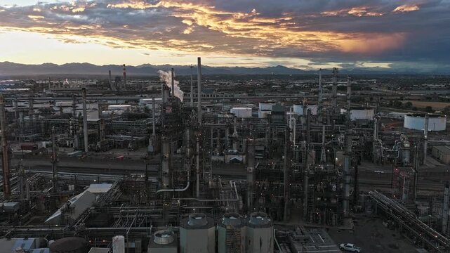 Oil industrial area petrochemical plant refinery at sunset smoke steam drone video smoke Denver Colorado 4K