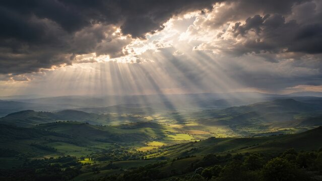Dramatic sunbeams pierce storm clouds, illuminating green rolling hills and a sweeping valley with warm golden light