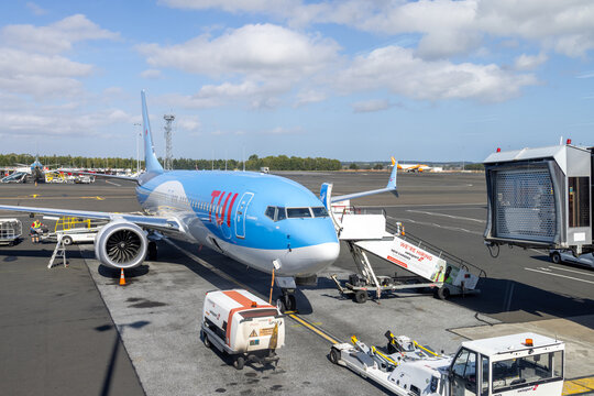 Newcastle, UK, 1st September 2026: TUI passenger aircraft parked on the airport apron with ground handling vehicles mobile stairs and airport equipment surrounding the plane before departure
