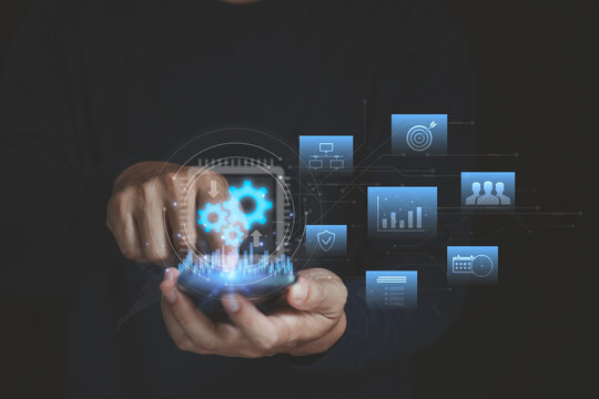 Businessman using a smartphone to analyze tab data on business integration. System unification, digital transformation, process automation, enterprise workflow and technology alignment strategies.