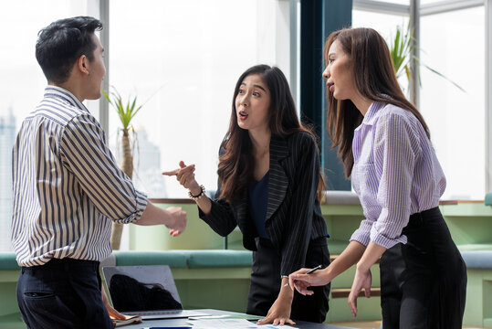 Gen Z Asian Business Consultants Collaborating and Sharing Ideas in a Modern Office and Coworking Space