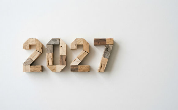 Wooden numbers 2027 made of recycled wood blocks on a white background representing the future year and new beginning