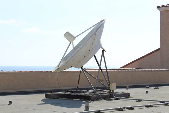 Rooftop Satellite Dish Antenna on top of a roof.