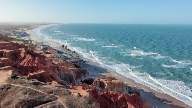 Aerial drone view of red cliffs and turquoise sea at Morro Branco, Ceara, Brazil