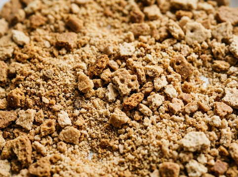 Crushed biscuit texture. Granular food crumbs background