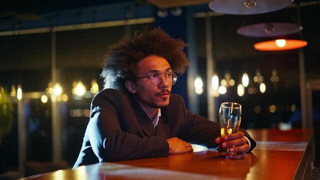 Thoughtful man holding beer glass bar counter. Close up pensive guy night pub.