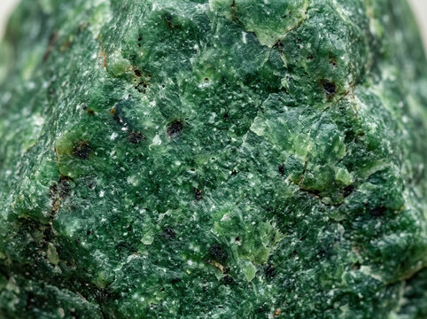 Macro texture of raw jade green nephrite stone. Mineral surface background