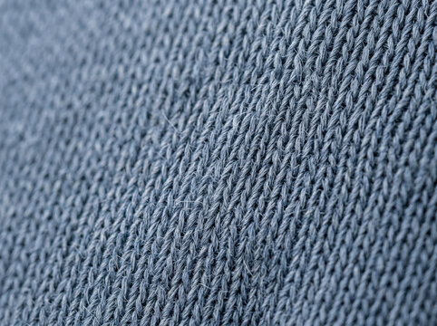 Synthetic jersey knit fabric texture. Close-up of blue gray textile