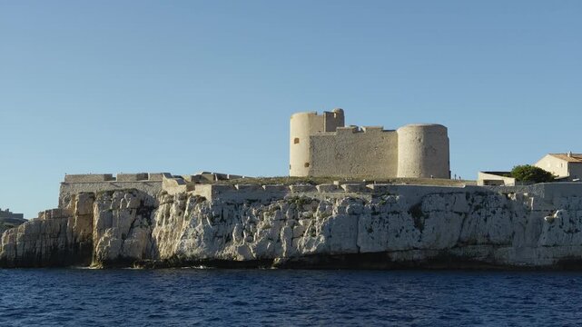 Scenic view of the famous Chateau d'If fortress on its island, seen from a navigating boat