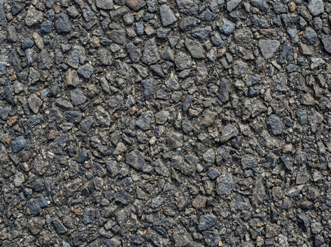 Asphalt tarmac road surface texture. Gray stone aggregate background