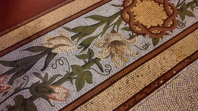 Close-up of the Venetian tile floor featuring cockspur coral tree flower and lily motifs inside the Metropolitan Cathedral of Buenos Aires.