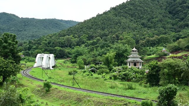 Lamphun, Thailand  September 21, 2026 A State Railway of Thailand (SRT) train operating on the Bangkok&ndash;Chiang Mai route passes over the Tha Chomphu Bridgealso known as the White Bridgeat 1045 AM in La