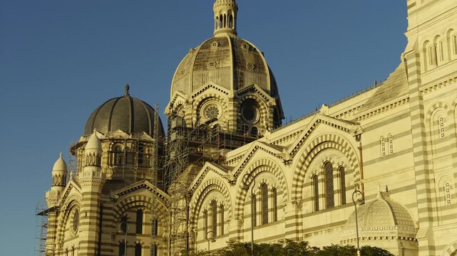 Majestic facade of the Cathedrale La Major in Marseille, France, illuminated by the golden hour light