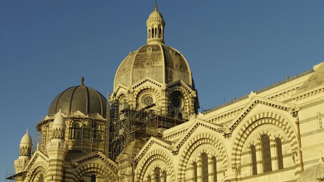 Striking architecture of the Cathedrale La Major in Marseille, France, against a clear blue sky