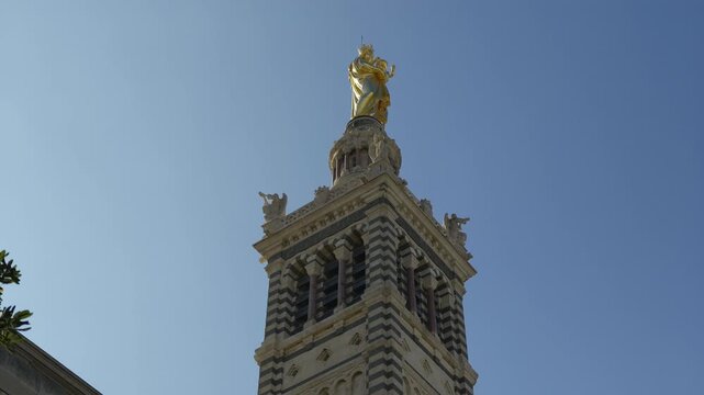 The golden statue of the virgin Mary at the top of the bell tower of Notre Dame de la Garde basilica