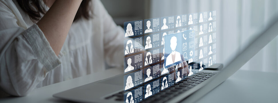 Woman Using Laptop with Virtual Interface and Digital Portraits Representing Online Networking and Communication in Modern Workplace Environment. Entropy.