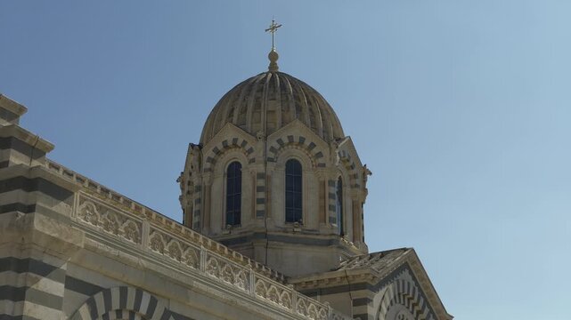 Architectural detail of the dome of Marseille Cathedral against a clear blue sky in France