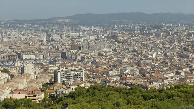 Scenic high angle view of the urban landscape of Marseille, with buildings and mountains in summer