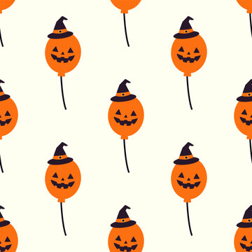 Halloween seamless pattern featuring orange pumpkin balloons wearing witch hats on white background