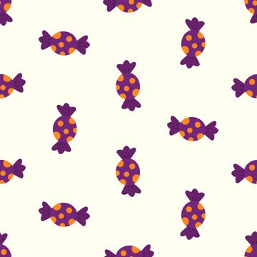 Seamless pattern of purple Halloween candy with orange polka dots on white background