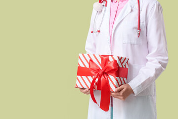 Obraz premium Healthcare appreciation and medical staff bonus, doctor holding a gift box with red ribbon for holiday celebration or patient gratitude in hospital
