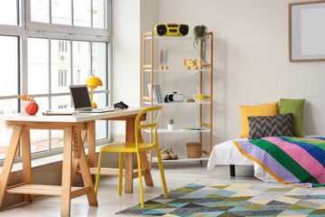 Remote work and study from home, modern bedroom interior with laptop desk and colorful decor for student or freelancer lifestyle in a bright apartment © Pixel-Shot