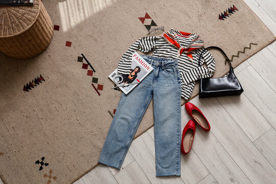 French style and fashion trends casual outfit with striped shirt blue jeans red ballet flats and accessories on a patterned rug for lifestyle blogger