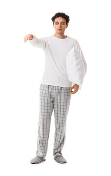 Young male sleepwalker with pillow isolated on white background