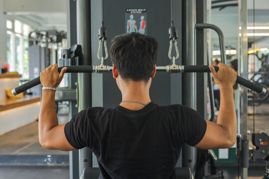 Dedicated Male Working Out Strength And Endurance Inside Modern Exercise Club