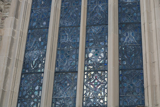 Detail of blue leaded glass and stone mullions